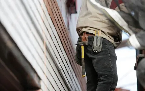 Construction site workers in Sydney — power tools and extension leads on building sites require 3-monthly test and tag under AS/NZS 3760